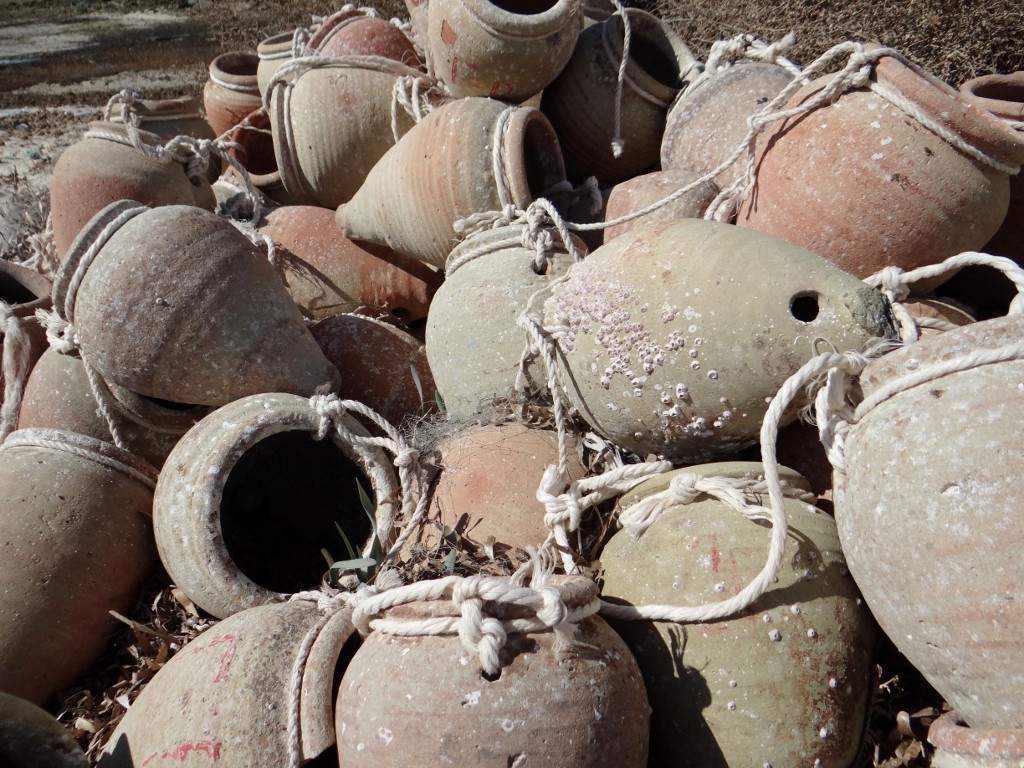 Octopus pots stacked up waiting to be used, there are loads more buried in the sand.