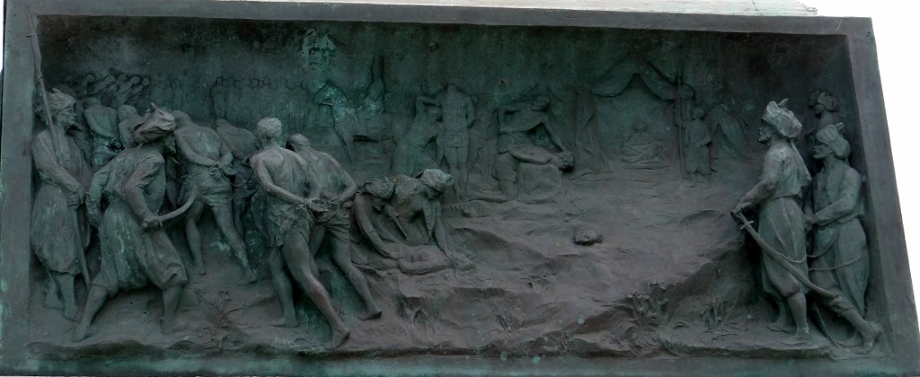 The memorial in the town centre depicts the beheadings
