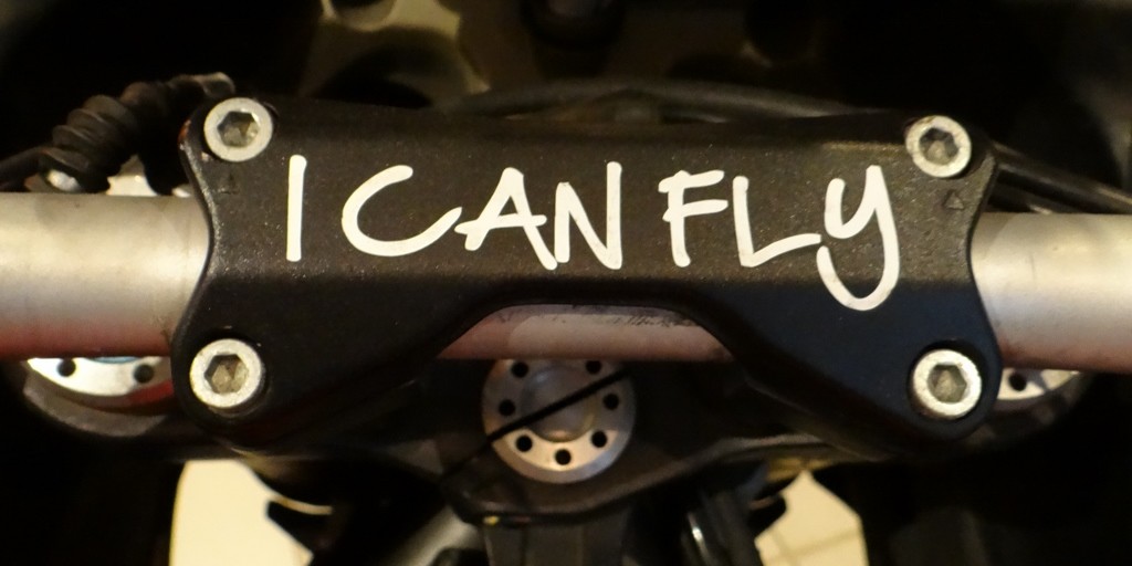 Written on the handlebar clamp of a round the world Ducati. Respect