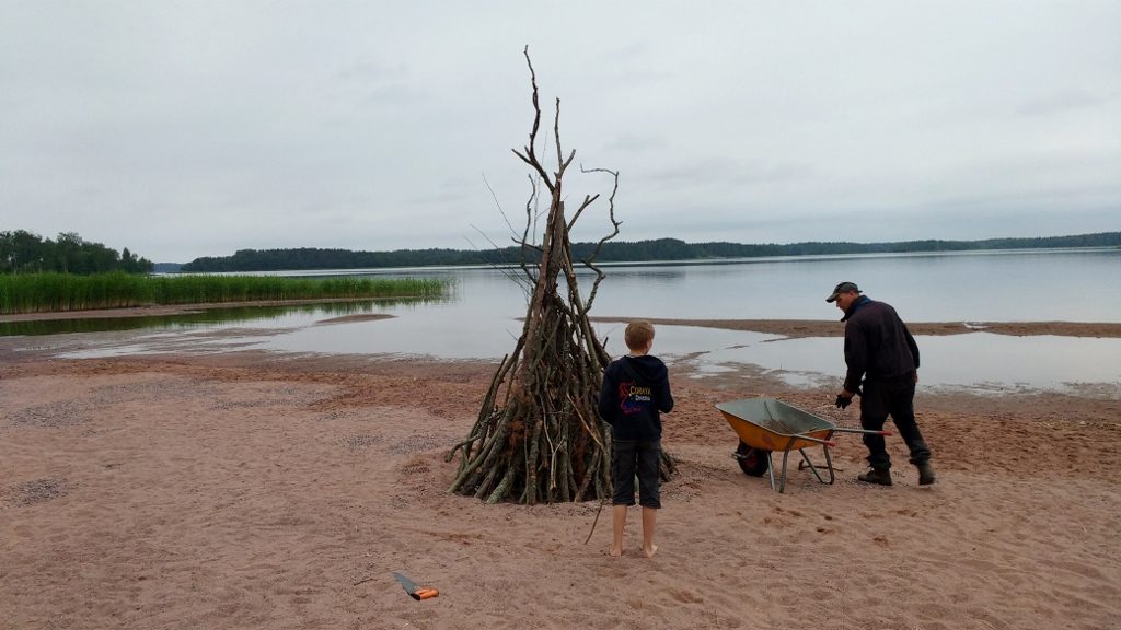 Pasi and his son building the Kokko (bonfire)