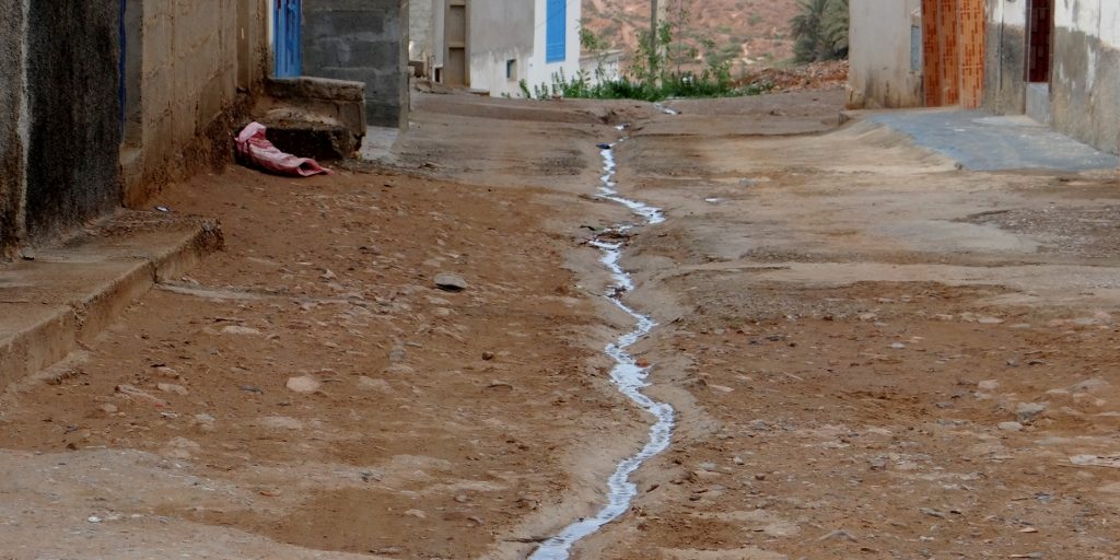 This is Morocco: walking down a street with an open drain