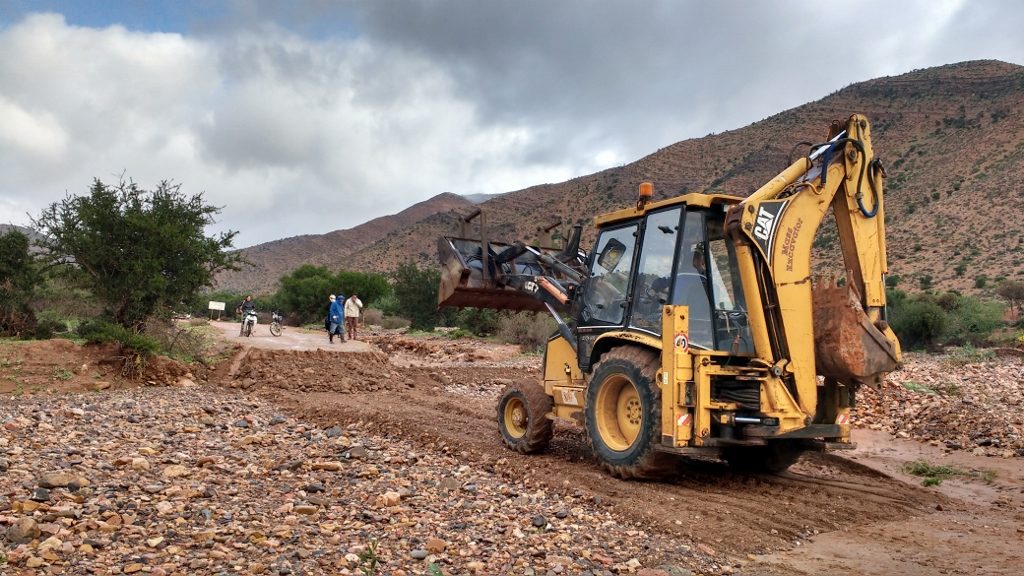A JCB shoving the river bed back into place to recreate the piste road to Camping de la Vallee