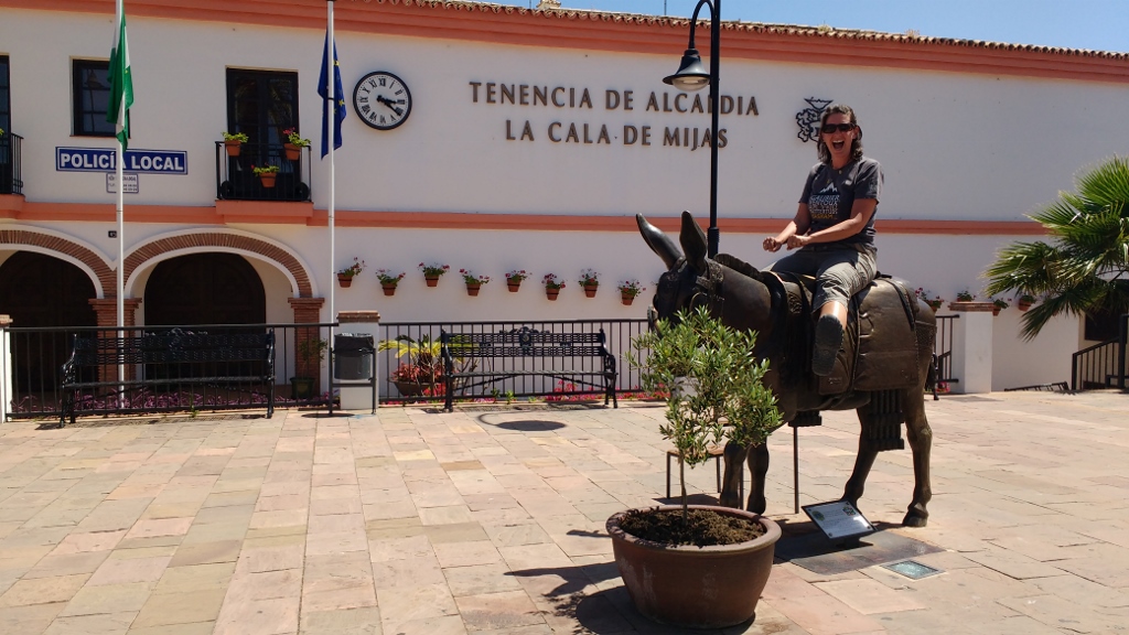 Ju takes to the super-heated back of a metal donkey in Mijas
