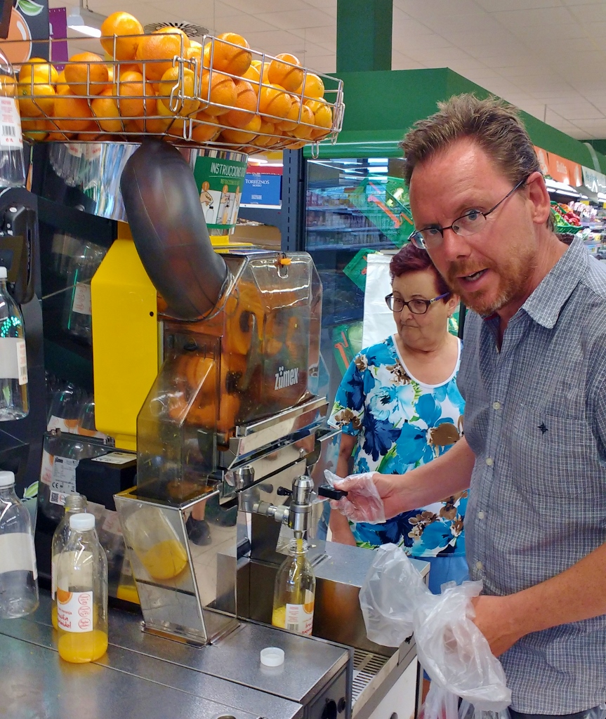 Orange juice machine in supermarket