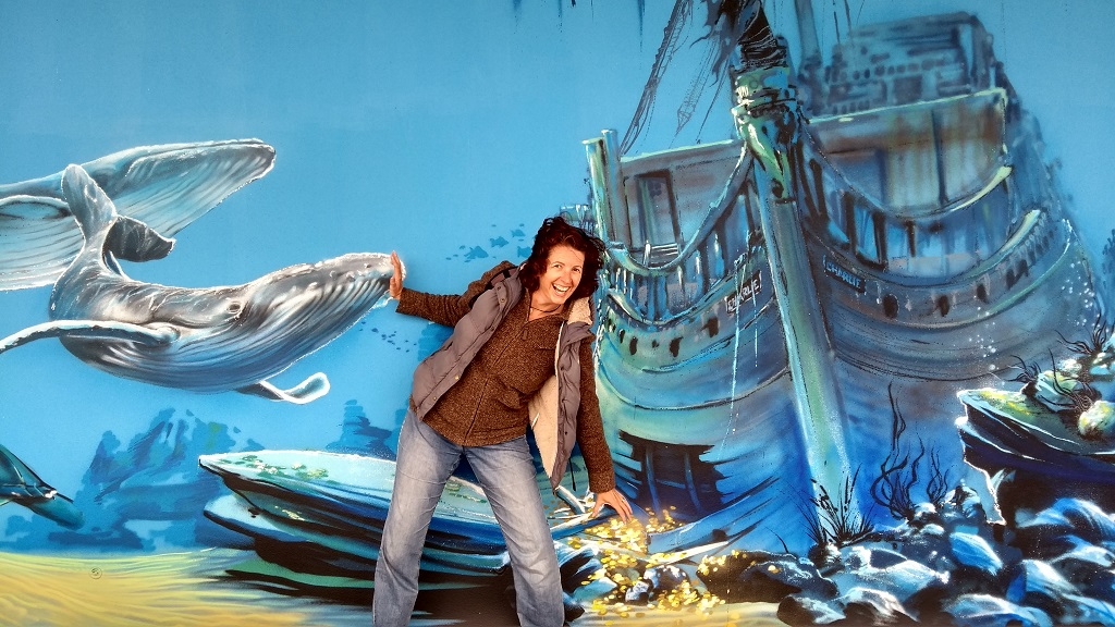 Mucking about by a beautiful undersea-mural brightening up a grey wall at Stella Plage