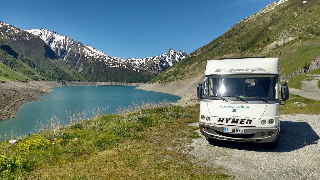 motorhome by lake and mountains