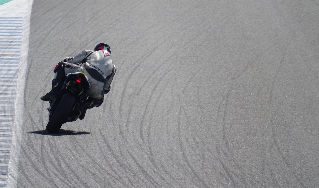Those black lines are rubber, where the big bikes have slid their rear wheels along the tarmac at silly speeds