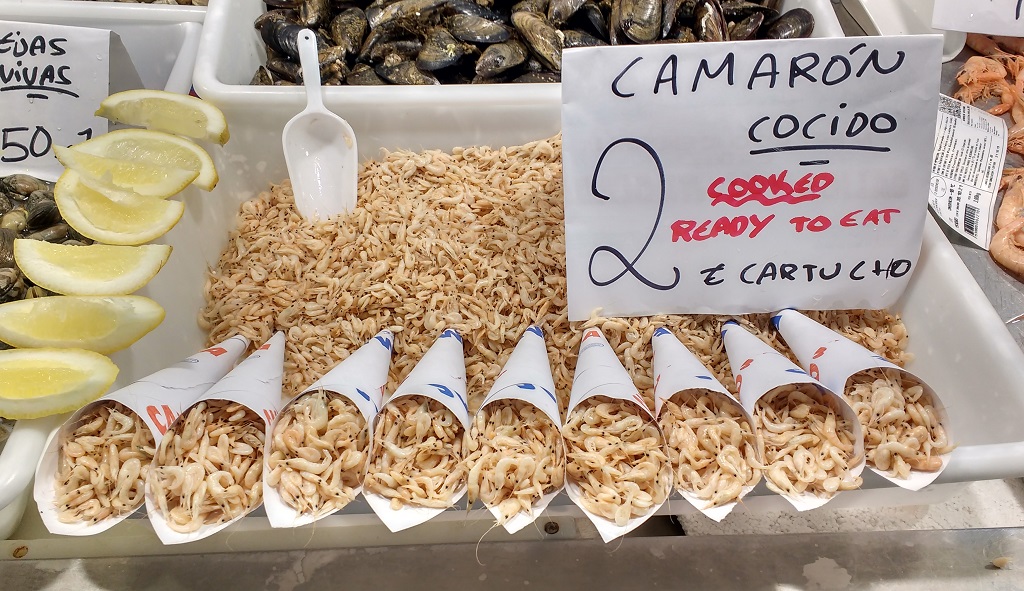 Small cooked shrimps in cones at the central market in Cadiz