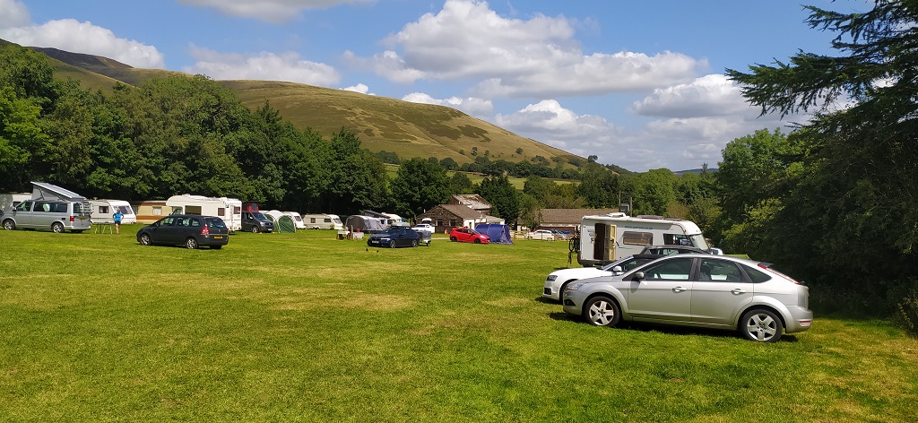 Small motorhomes and campervans at Newfold Farm Campsite in Edale