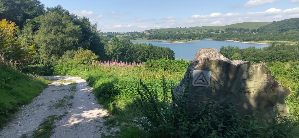 The track around Carsington Water with a dire warning to cyclists taking the descent too quickly!