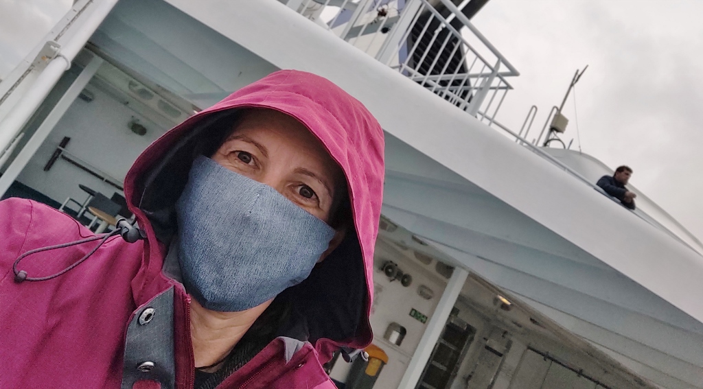 In mask on ferry to Spain