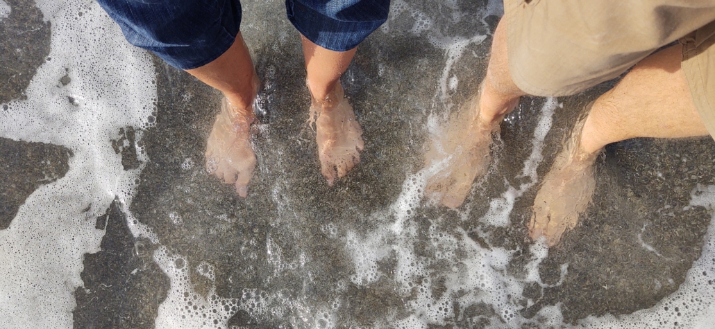 feet soaking in the sea