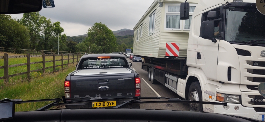 Static caravan on a lorry through a motorhome windscreen.