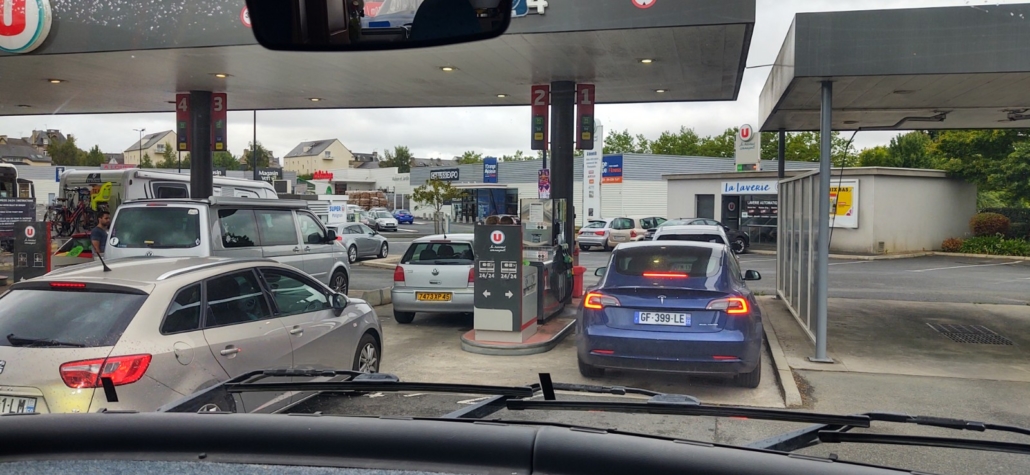 The unexpected sight of a Tesla (electric) car in front of us at the petrol station (he was filling some containers in the boot)