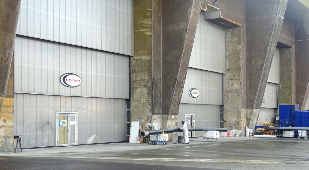 Lorima logos on giant doors of the K1 sub pen entrances at Lorient. They make carbon masts for very expensive yachts