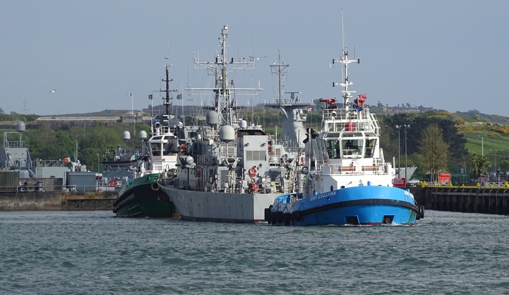 Warship being towed out of Haulbowline Island
