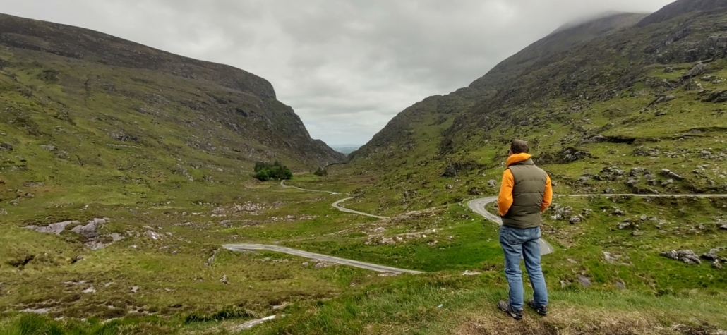 Tourist walker looking down over gap of dunloe ireland
