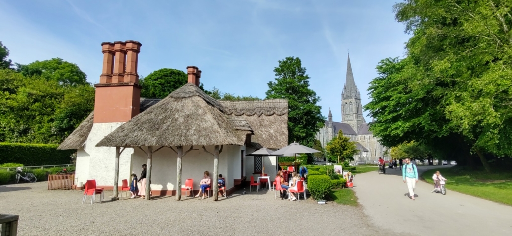 thatched cottage with cathedral in background, Killarney Ireland
