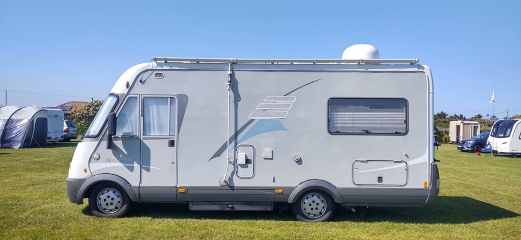 Hymer motorhome with guttering and downpipe for capturing rainwater