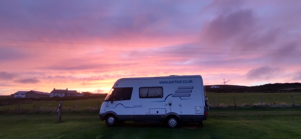 Motorhome and colourful sunset sky