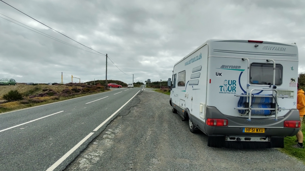 Motorhome and van parking in a lay bye opposite the height barrier car parking at Parys Mountain, Anglesey