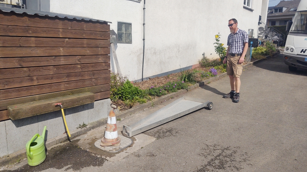 Clever drive over grey water drain direction device on a stellplatz in Germany