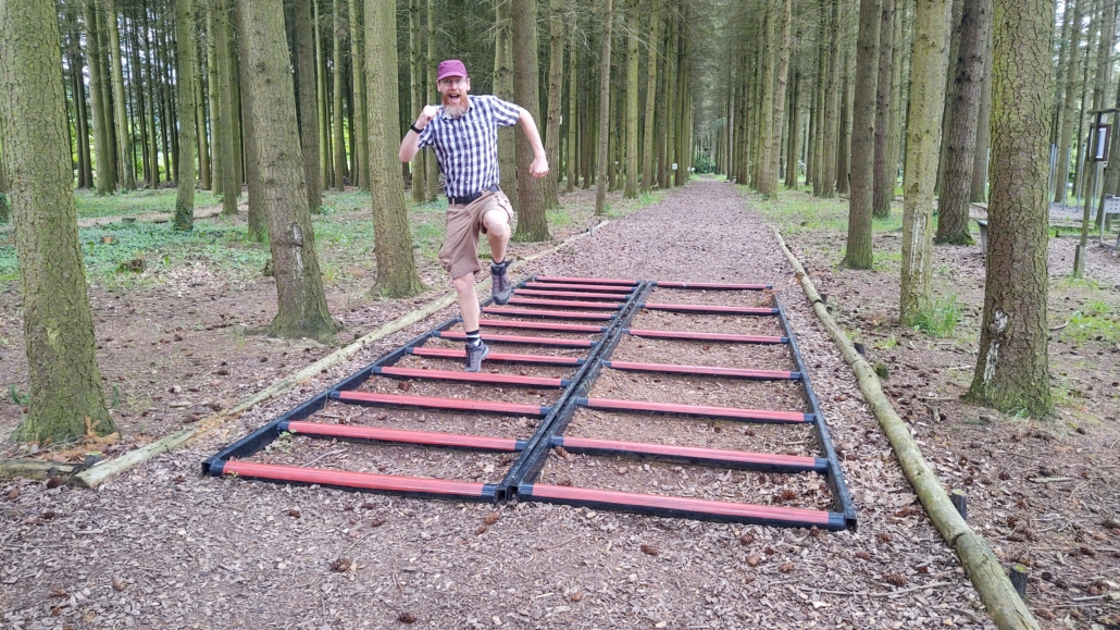 Man-child mucking about in the forest.