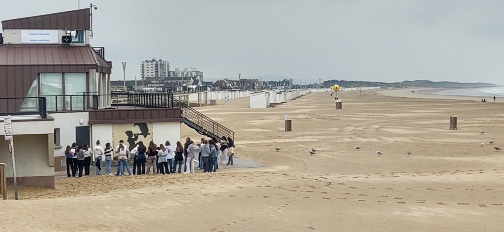 Students studying Banksy art at Calais