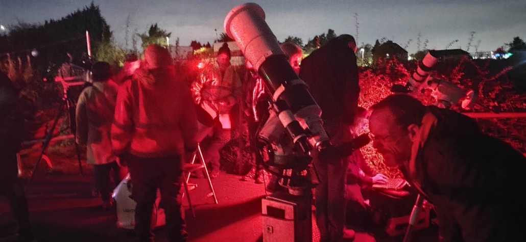 Jay looking through a telescope 