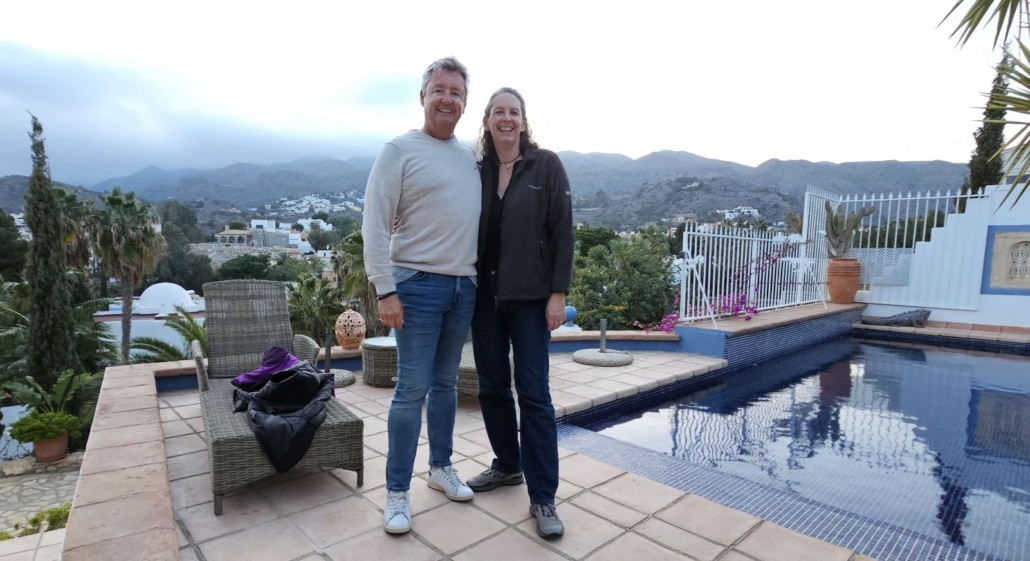 Julie and her brother on the side of the pool in Spain