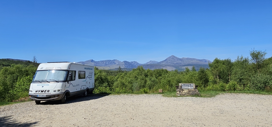 Motorhome in car park with view of mountains