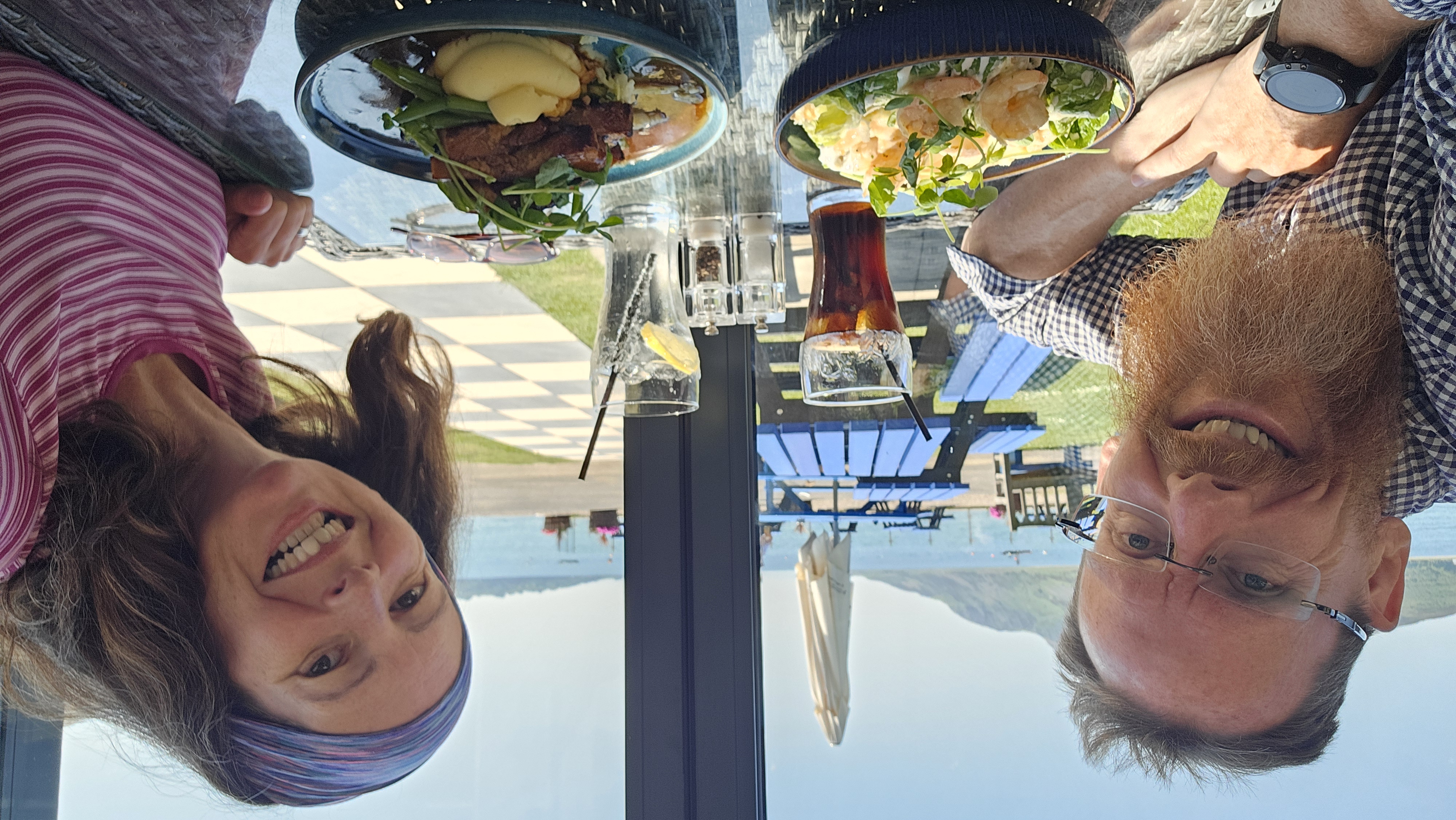 Both of us sat at a table of food with a view out over the sea