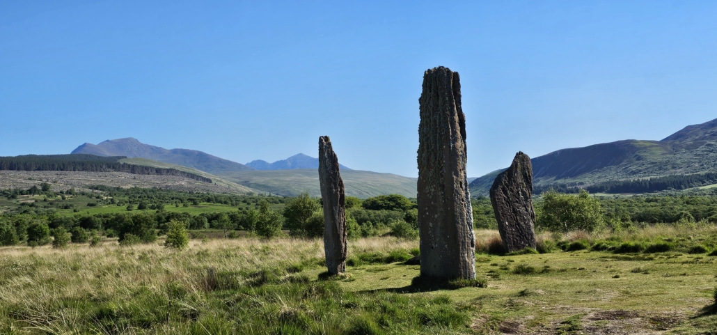 Three large standing stones in a field