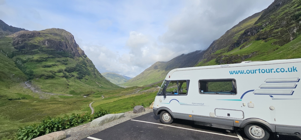 motorhome parked overlooking green mountains