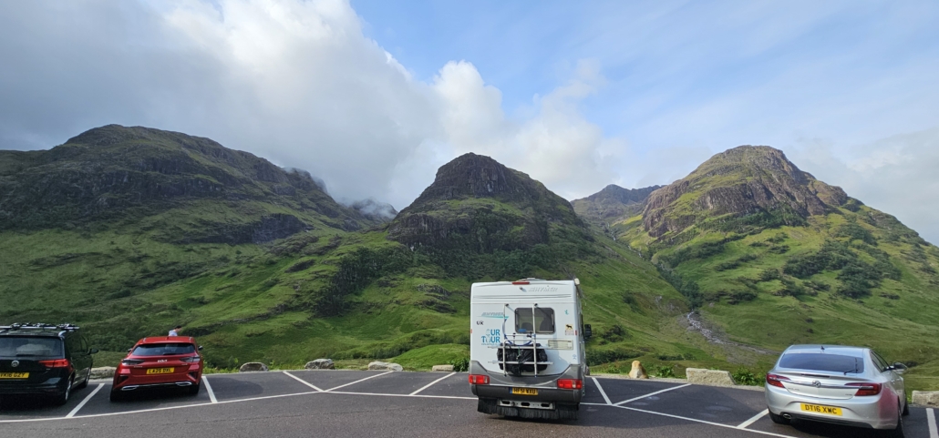 motorhome parked overlooking green mountains