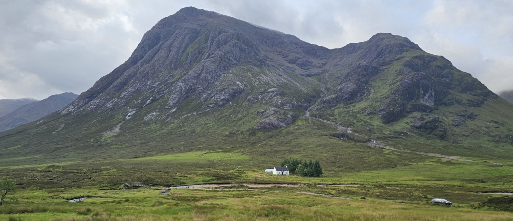 Small cottage with huge mountain behind it