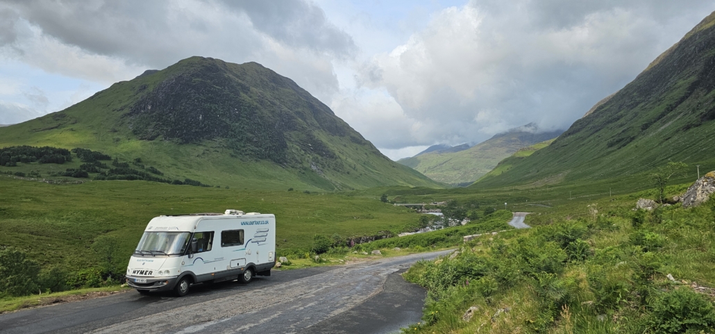 Motorhome parked in layby with mountains and valley behind
